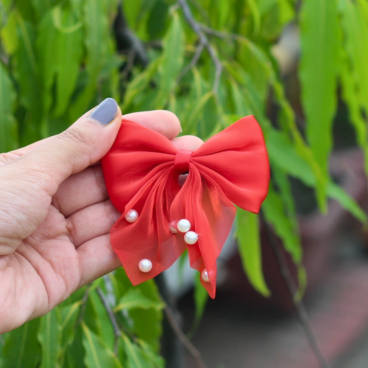 Mini Pearl Bow Hair Clips In Hand Overview Image